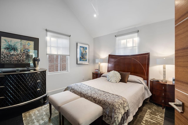 bedroom featuring high vaulted ceiling and hardwood / wood-style flooring