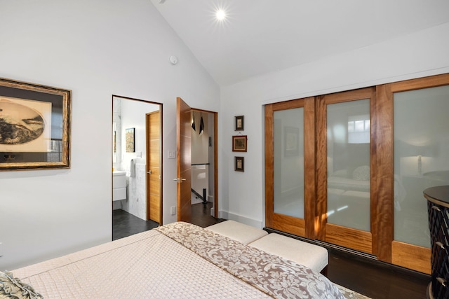 bedroom with french doors, dark hardwood / wood-style flooring, high vaulted ceiling, and connected bathroom