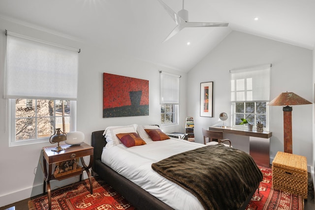 bedroom featuring vaulted ceiling, ceiling fan, and multiple windows