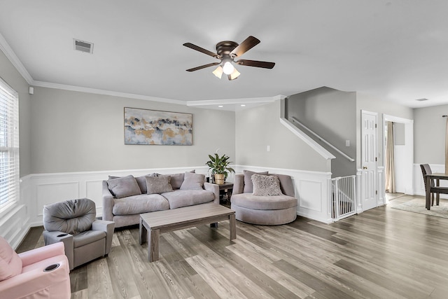 125 Towering Pine Dr, Ladson, SC 29456 - living area featuring ceiling fan, wood finished floors, a wainscoted wall, ornamental molding, and a decorative wall