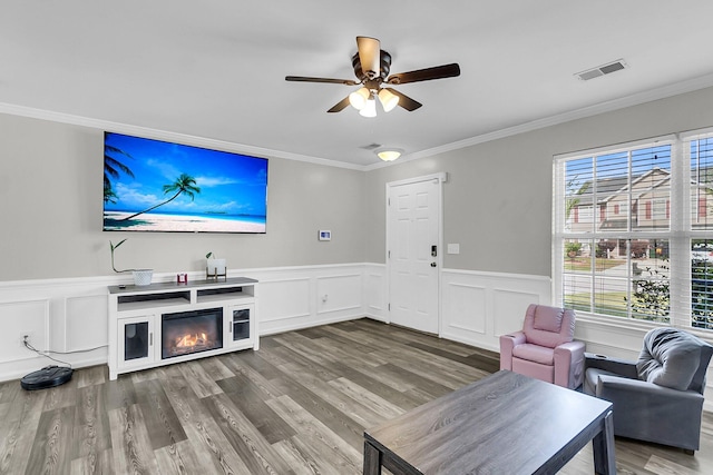 125 Towering Pine Dr, Ladson, SC 29456 - living room with ornamental molding, ceiling fan, wood finished floors, wainscoting, and a decorative wall
