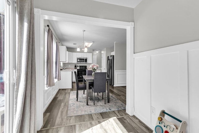 125 Towering Pine Dr, Ladson, SC 29456 - dining room with a wainscoted wall, wood finished floors, and a decorative wall