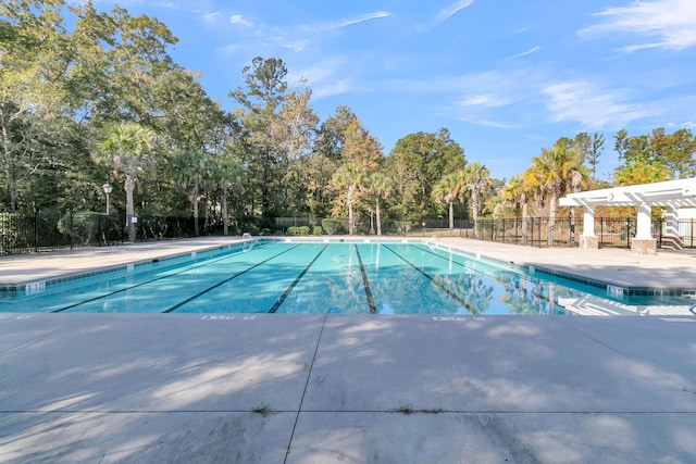 125 Towering Pine Dr, Ladson, SC 29456 - community pool with view of scattered trees and a patio area