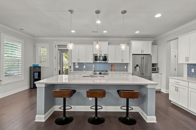 kitchen featuring white cabinets, dark wood-style floors, stainless steel appliances, crown molding, and a sink