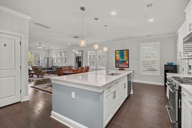 kitchen featuring visible vents, appliances with stainless steel finishes, a sink, and ornamental molding