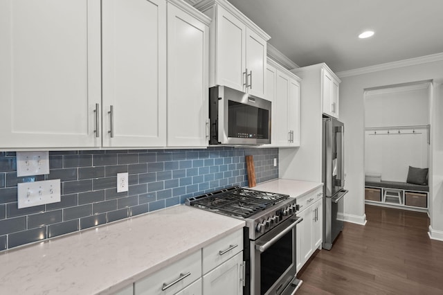 kitchen with dark wood finished floors, crown molding, decorative backsplash, white cabinets, and high quality appliances