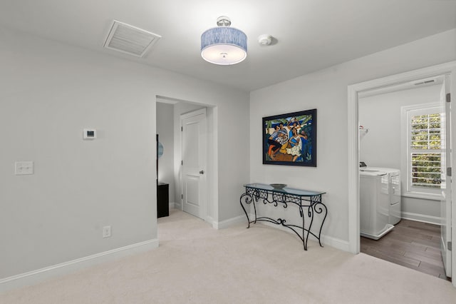 interior space with washer and clothes dryer, carpet flooring, visible vents, and baseboards