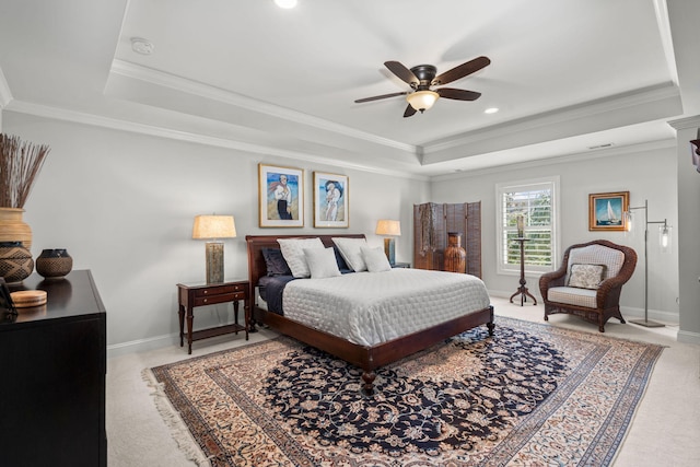 bedroom featuring ornamental molding, a raised ceiling, and light carpet