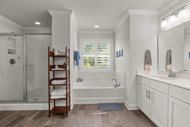 bathroom with vanity, a shower stall, a bath, wood tiled floor, and crown molding