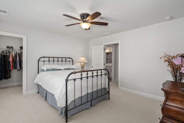 bedroom featuring baseboards, visible vents, light colored carpet, a spacious closet, and a closet