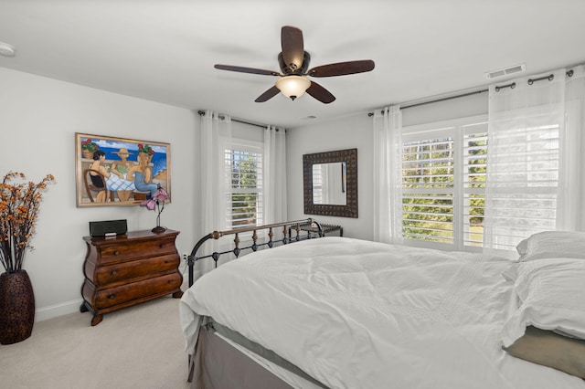 bedroom with ceiling fan, carpet, visible vents, and baseboards