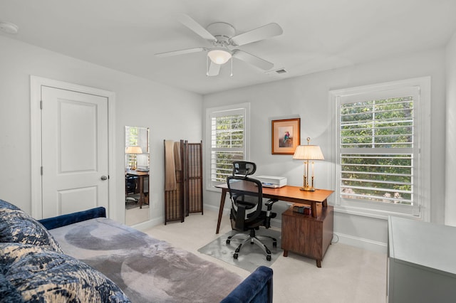 interior space with light carpet, baseboards, and a ceiling fan