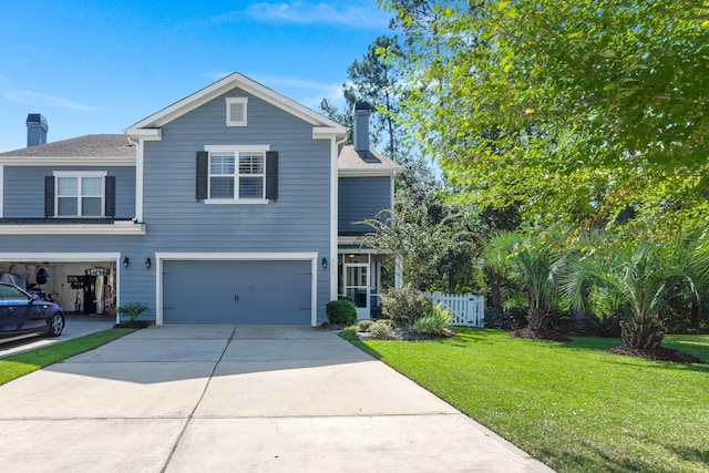 traditional home featuring a chimney, concrete driveway, an attached garage, a front yard, and fence