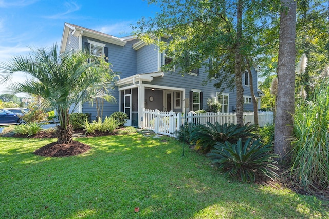 view of front of house with a gate, fence, and a front lawn