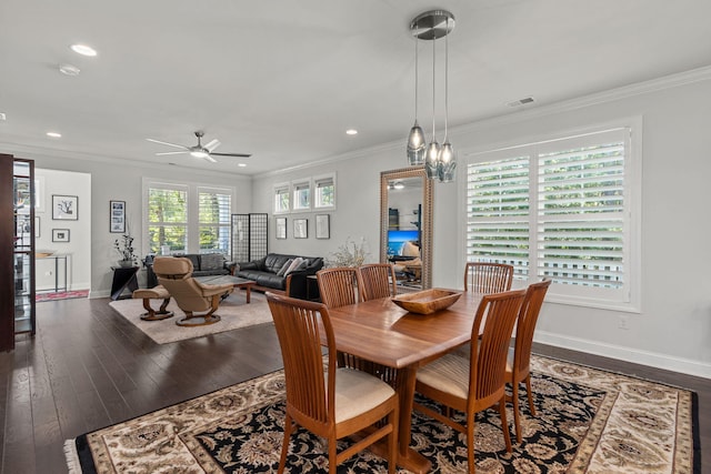 dining space with wood-type flooring, visible vents, and crown molding