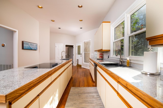 kitchen with recessed lighting, black electric stovetop, a sink, and wood finished floors