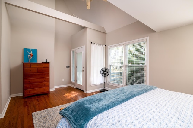 bedroom featuring a ceiling fan, vaulted ceiling, baseboards, and wood finished floors