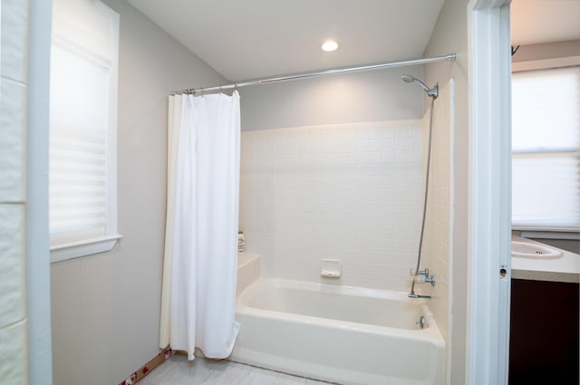 bathroom with a wealth of natural light, vanity, recessed lighting, and shower / bath combo