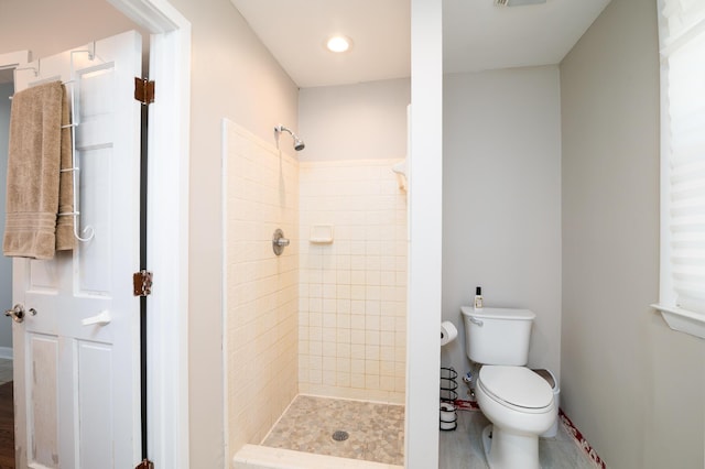 bathroom with toilet, a shower stall, and visible vents