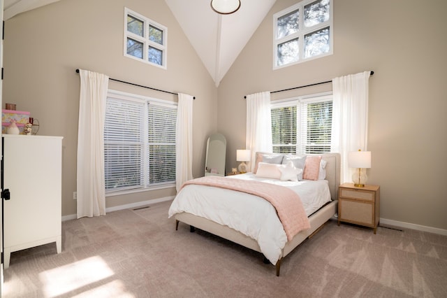 bedroom with high vaulted ceiling, baseboards, and light colored carpet