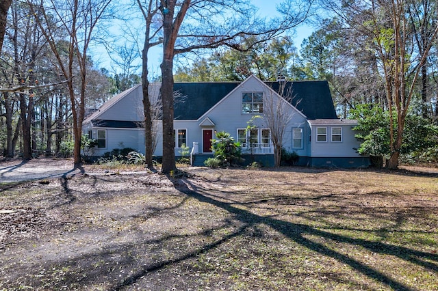 view of front of house with crawl space and a chimney