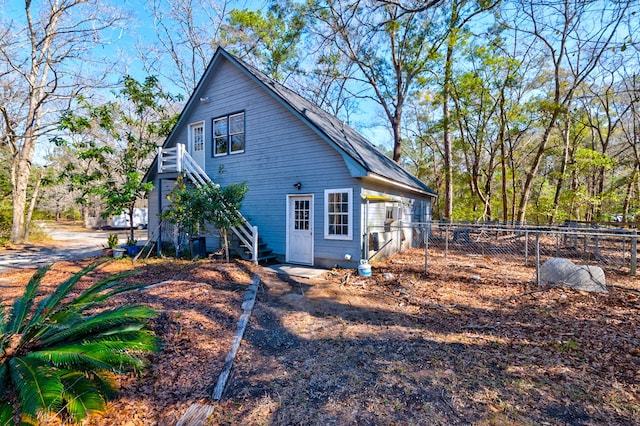 view of side of home with fence