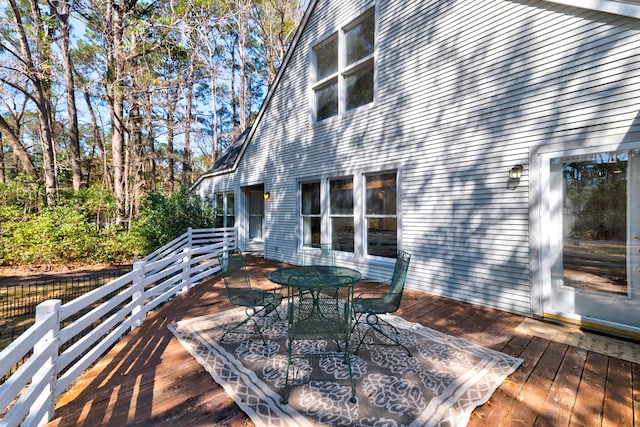 wooden terrace with outdoor dining area