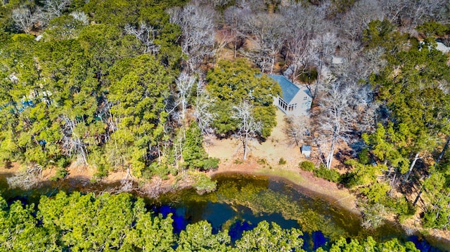 drone / aerial view with a water view and a wooded view