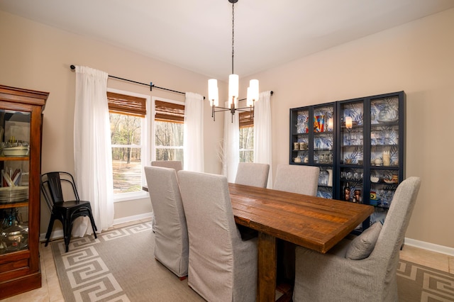 dining room featuring an inviting chandelier and baseboards