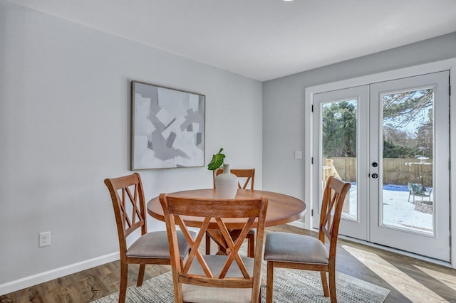 dining area featuring light wood-type flooring and french doors