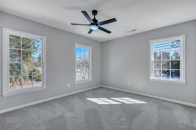 spare room with ceiling fan and carpet flooring