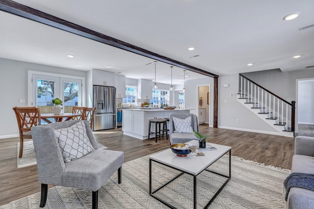 living room with hardwood / wood-style floors and beam ceiling