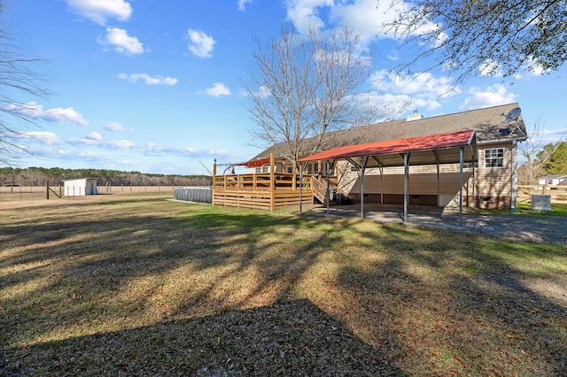 view of yard featuring a storage shed and a deck