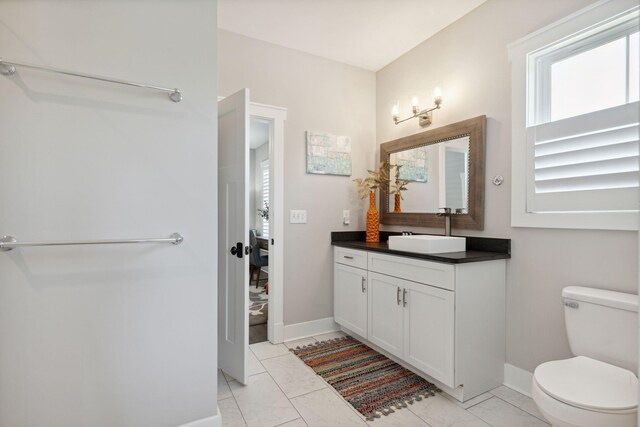 bathroom featuring vanity, toilet, and tile patterned flooring