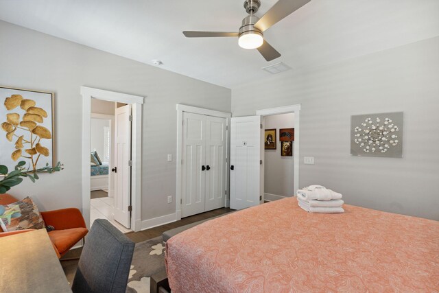 bedroom with dark wood-type flooring, a closet, and ceiling fan