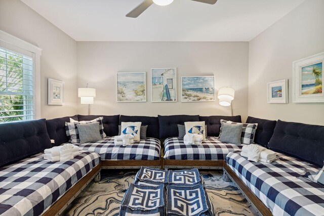 living room featuring wood-type flooring and ceiling fan