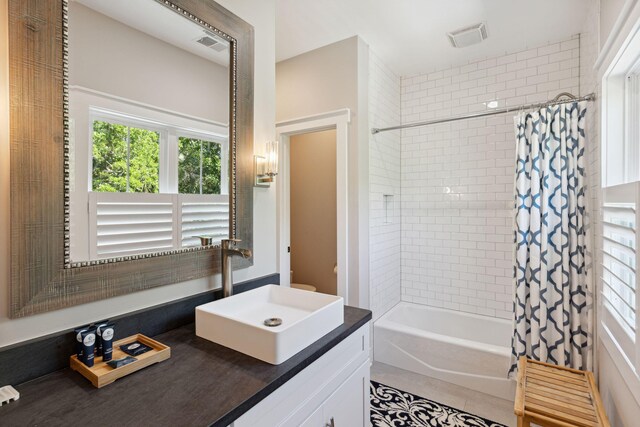 bathroom with vanity, shower / bath combination with curtain, and tile patterned floors