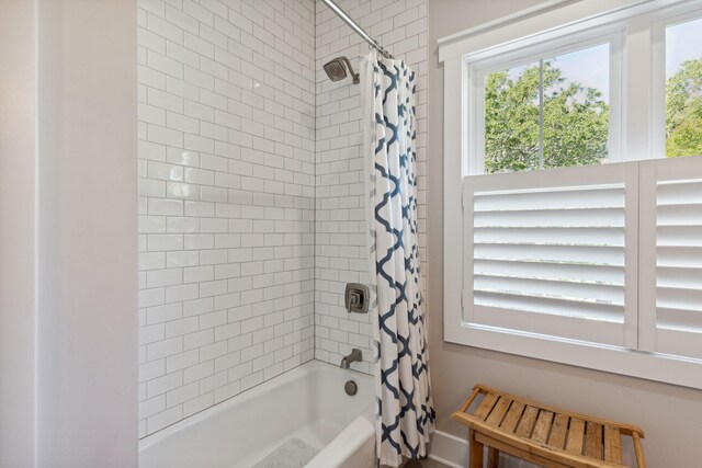 bathroom with shower / bath combo with shower curtain