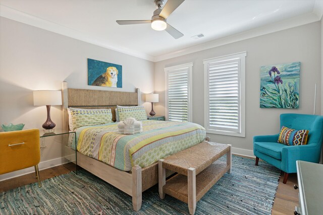 bedroom featuring crown molding, ceiling fan, and dark hardwood / wood-style flooring