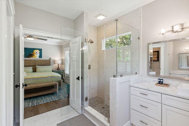 bathroom with vanity, hardwood / wood-style flooring, an enclosed shower, and ceiling fan