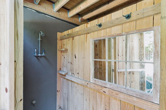 interior details featuring wood ceiling, beamed ceiling, and wood walls