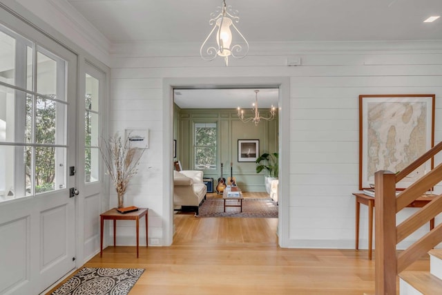 222 Haddrell St, Mount Pleasant, SC 29464 - foyer entrance featuring a chandelier, light wood-style floors, stairs, ornamental molding, and wood walls