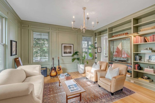222 Haddrell St, Mount Pleasant, SC 29464 - living room featuring a chandelier, a decorative wall, and wood finished floors