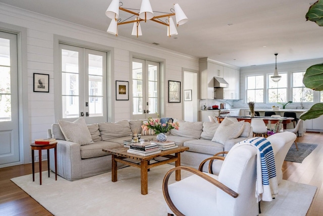 222 Haddrell St, Mount Pleasant, SC 29464 - living area featuring french doors, wood finished floors, ornamental molding, and a chandelier