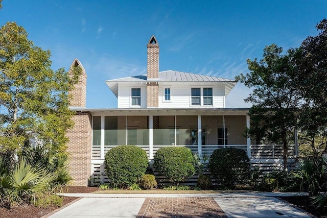 222 Haddrell St, Mount Pleasant, SC 29464 - back of house with a chimney, a standing seam roof, a sunroom, and metal roof