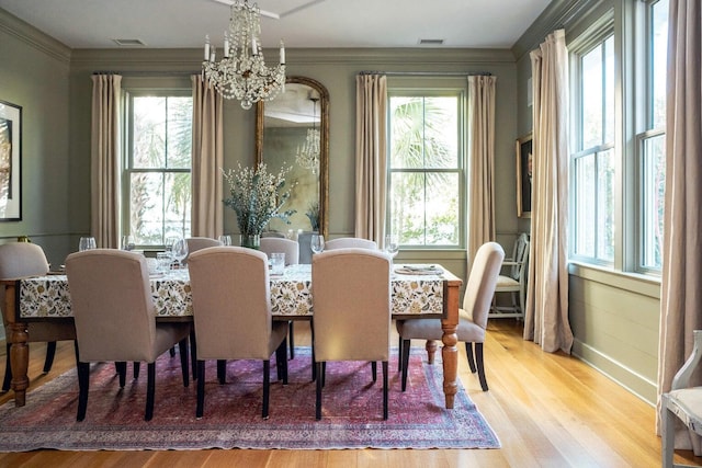 222 Haddrell St, Mount Pleasant, SC 29464 - dining area featuring a chandelier, healthy amount of natural light, ornamental molding, wood finished floors, and baseboards