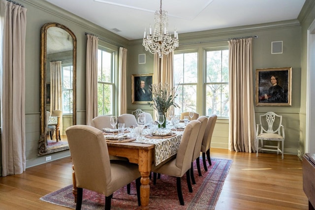 222 Haddrell St, Mount Pleasant, SC 29464 - dining room featuring a chandelier, plenty of natural light, wood finished floors, and ornamental molding