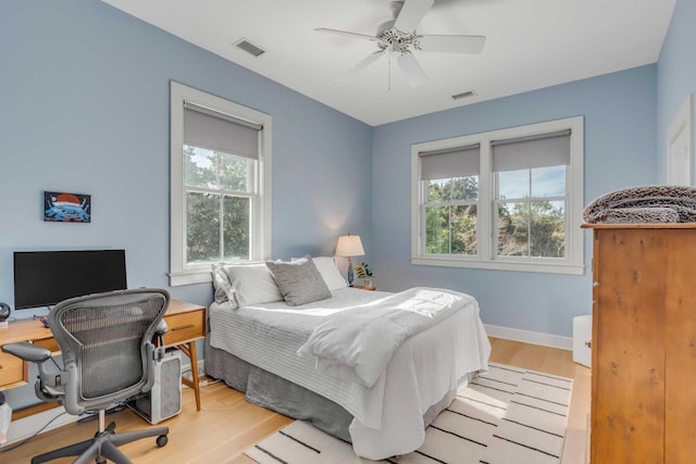 222 Haddrell St, Mount Pleasant, SC 29464 - bedroom with multiple windows, light wood-style flooring, a desk, and baseboards