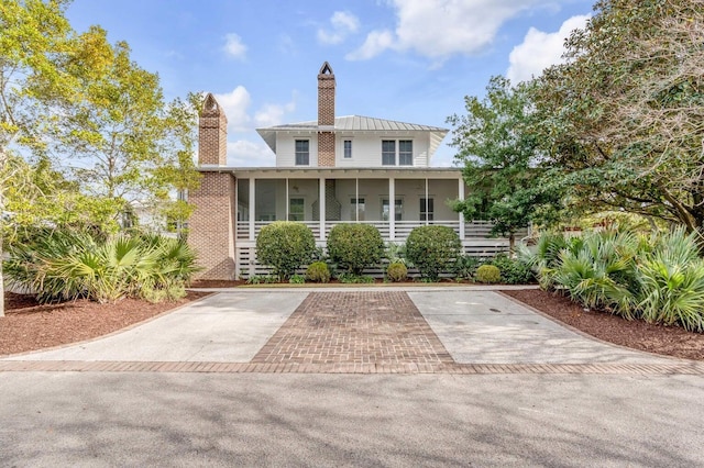 222 Haddrell St, Mount Pleasant, SC 29464 - view of front of home featuring a chimney, a sunroom, a standing seam roof, and metal roof
