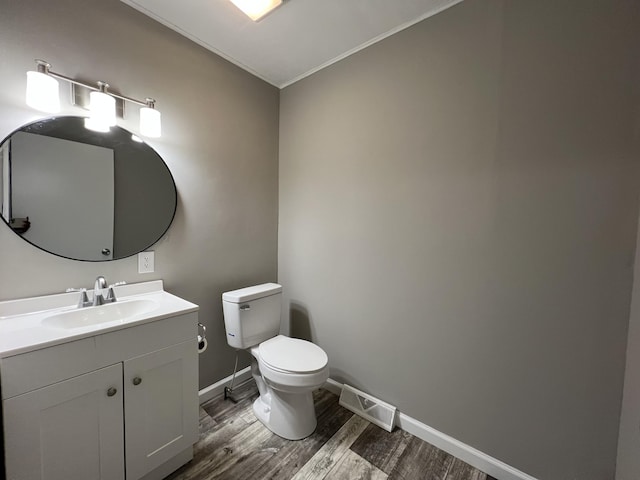 bathroom featuring hardwood / wood-style flooring, vanity, and toilet